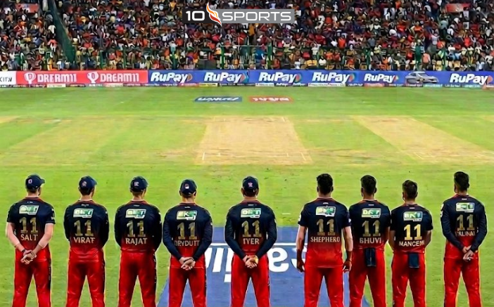 RCB Jersey No. 11 Tribute Explained: The Story Behind IPL 2026’s Most Emotional Moment RCB Jersey No. 11 Tribute Explained: The Story Behind IPL 2026’s Most Emotional Moment